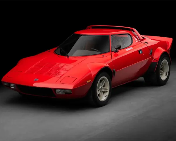 Czerwona Lancia Stratos, ikona rajdów, błyszczy na ciemnym tle.