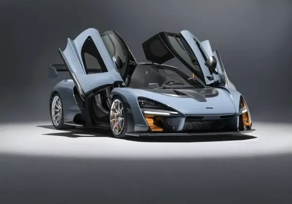Niebieski McLaren Senna z otwartymi drzwiami, gotowy do startu.